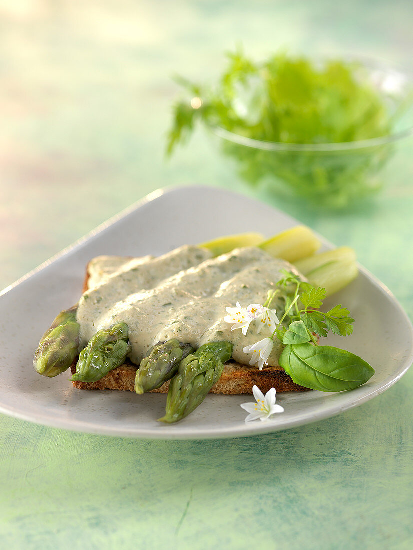 Toasted sandwich bread garnished with asparagus,creamy tofu sauce with tamarisk and herbs
