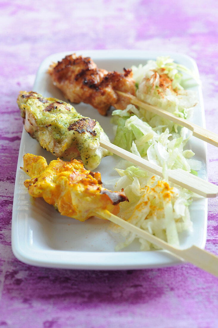 Three different flavored marinated chicken brochettes