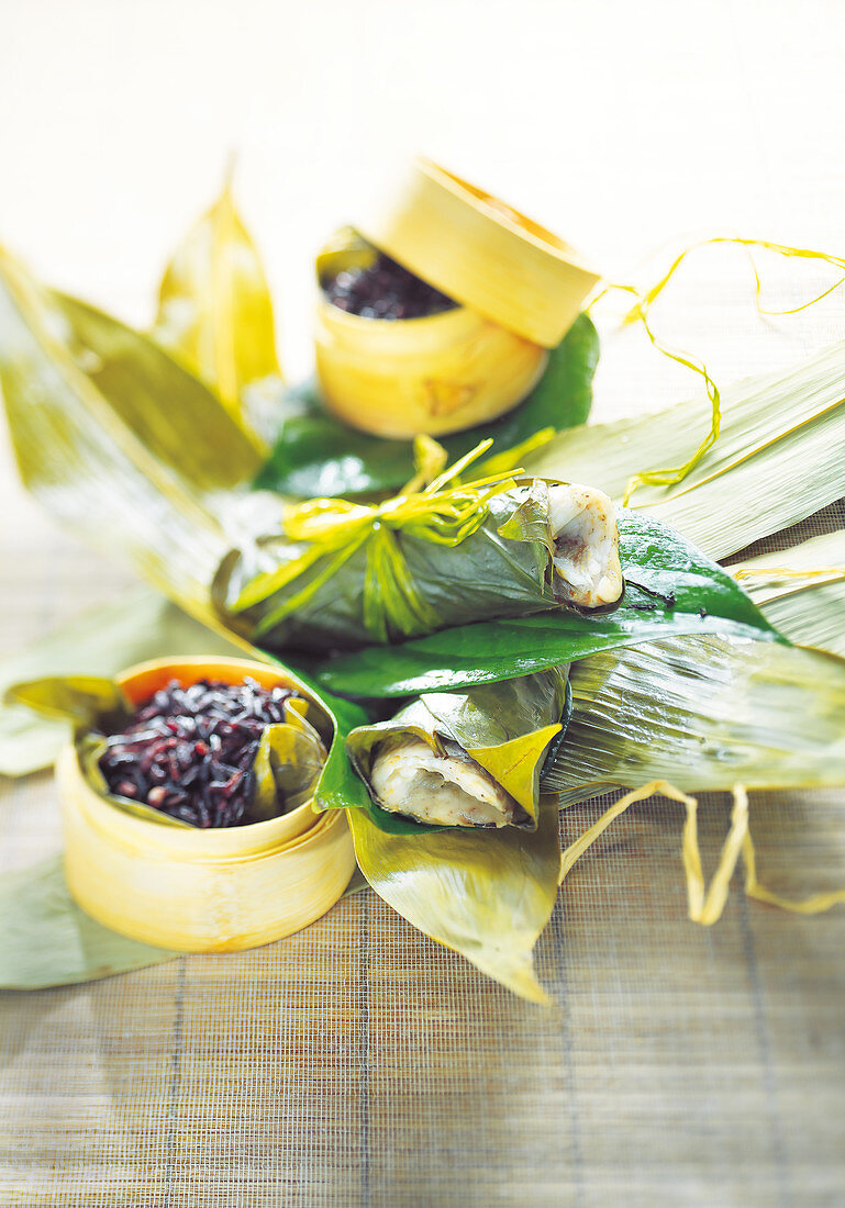 Bass fillets cooked in banana leaves,steamed black rice