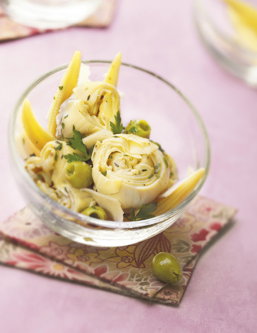 Marinated artichoke hearts with mini corn on the cobs and green olives