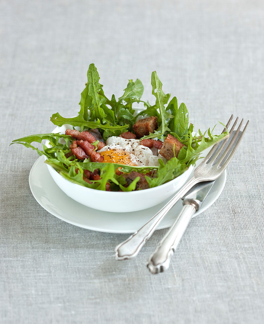 Dandelion,diced bacon and poached egg salad