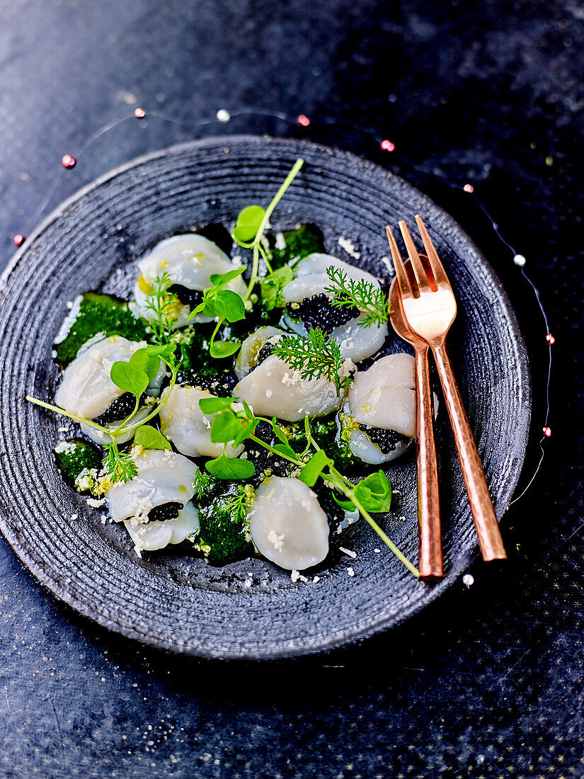 Scallop carpaccio with dill oil,herb sprouts,herring roe and grated horseradish
