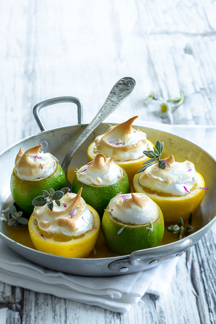 Lemons stuffed with citrus fruit cream and topped with meringue