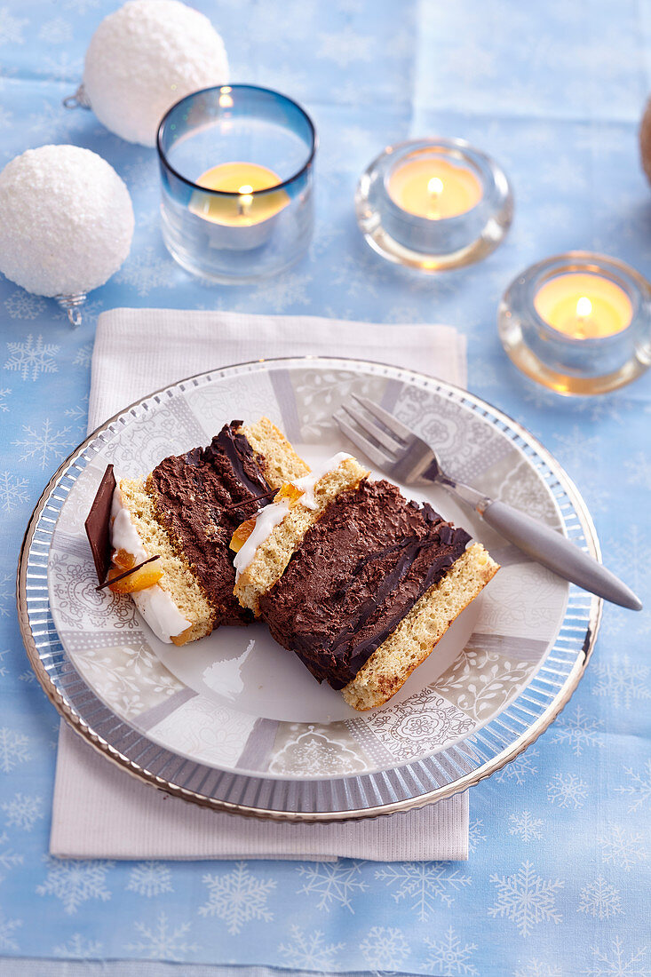 Chocolate log slices with sponge cake and candied orange peel