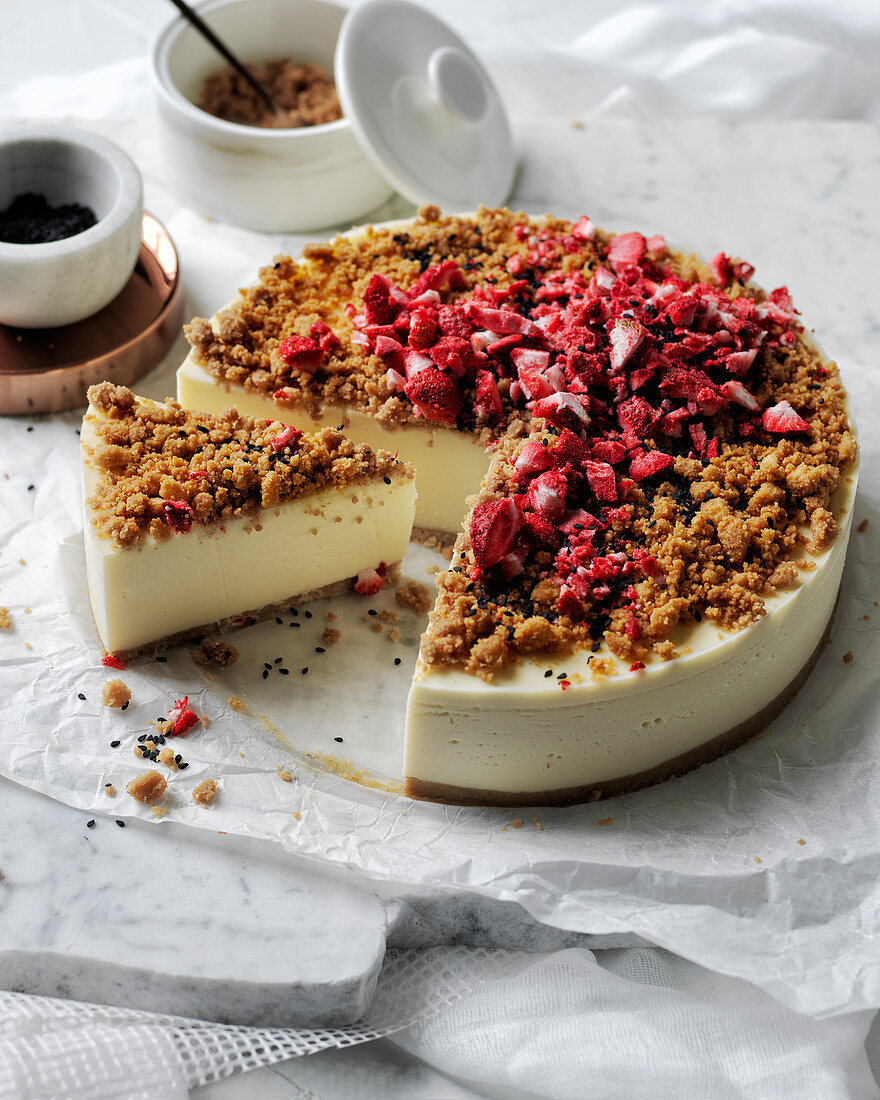 Cheese cake with dried strawberry crumble and black sesame topping