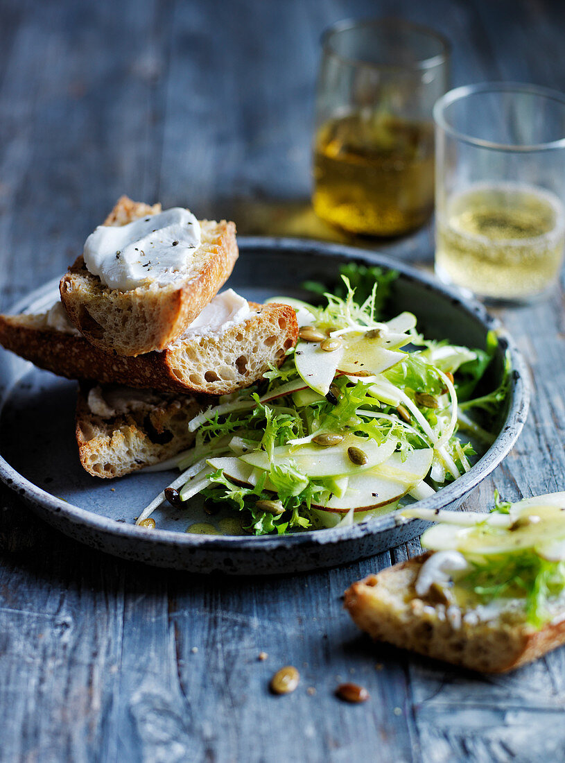 Pear, apple and frisée salad with goat curd toast