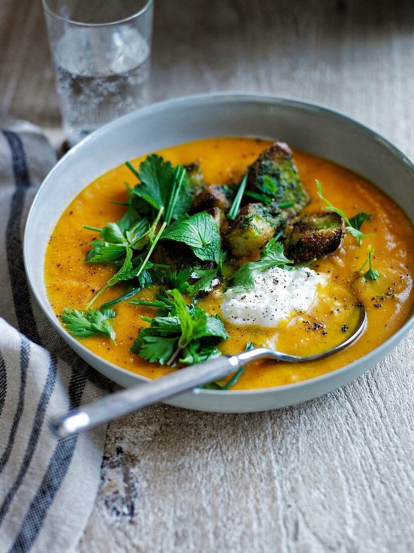 Sweet potato soup with garlic bread and fresh herbs