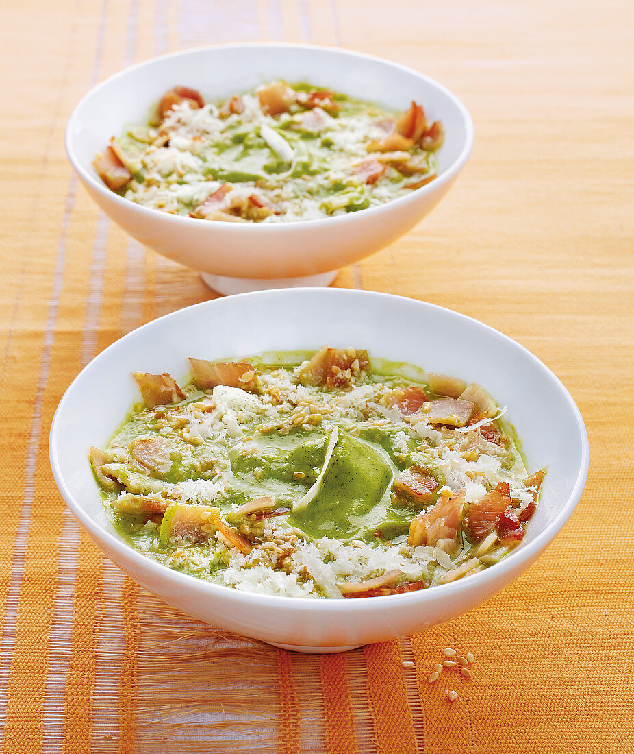 Crunchy zucchini soup with bacon, pine nuts and parmesan