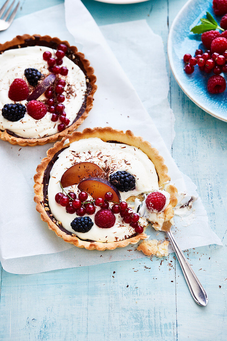 Two chocolate and summer fruit tartlets