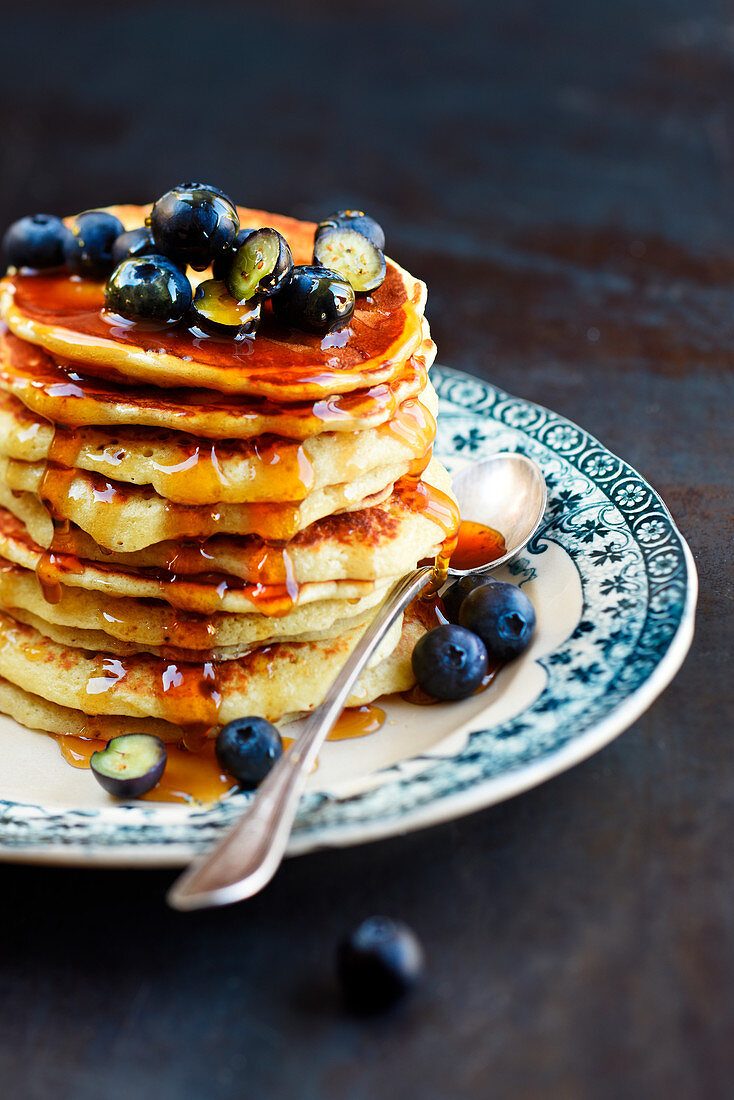 Pile of honey and blueberry pancakes