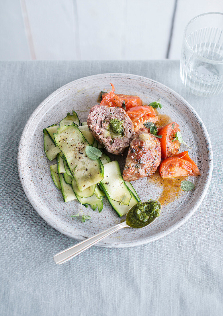 Veal meatball with pesto served with roasted tomatoes and courgette strips