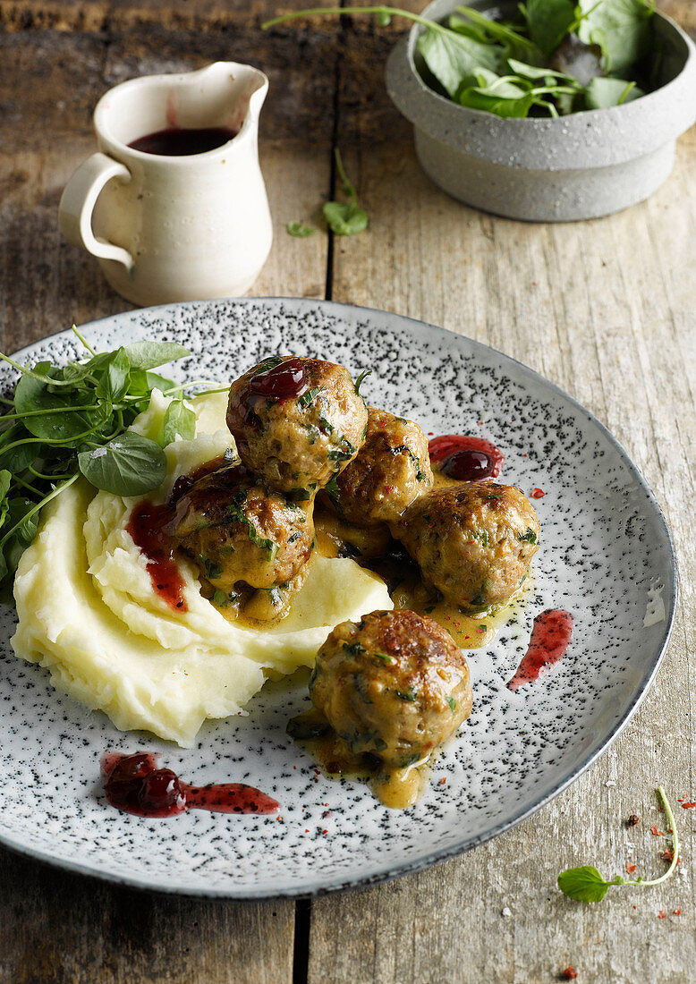 Meatballs with cranberry sauce on mashed potatoes