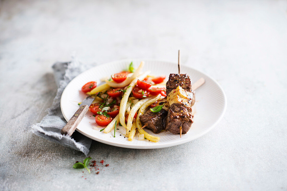 Beef halloumi skewer served with tomato salad with yellow beans