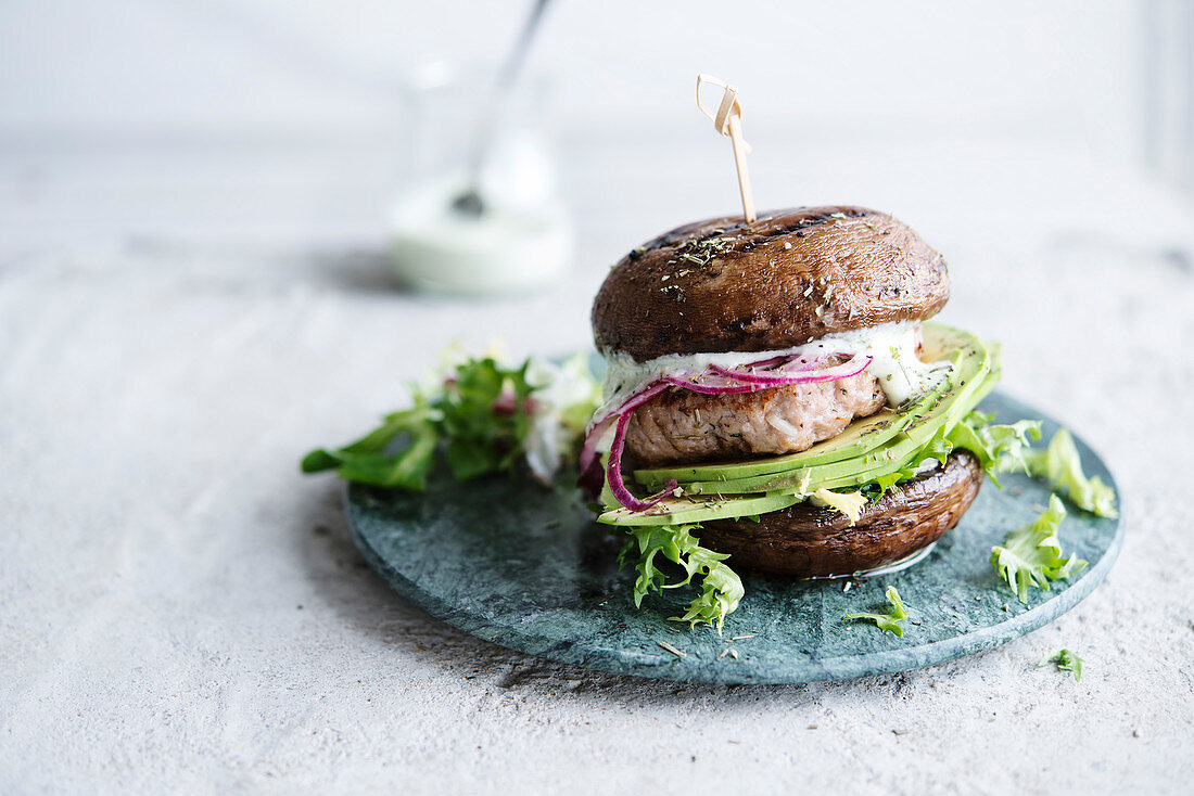 Portobello mushroom burger with chicken steak and avocado