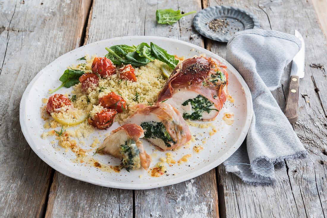 Chicken with spinach-ricotta stuffing served with semolina and tomatoes