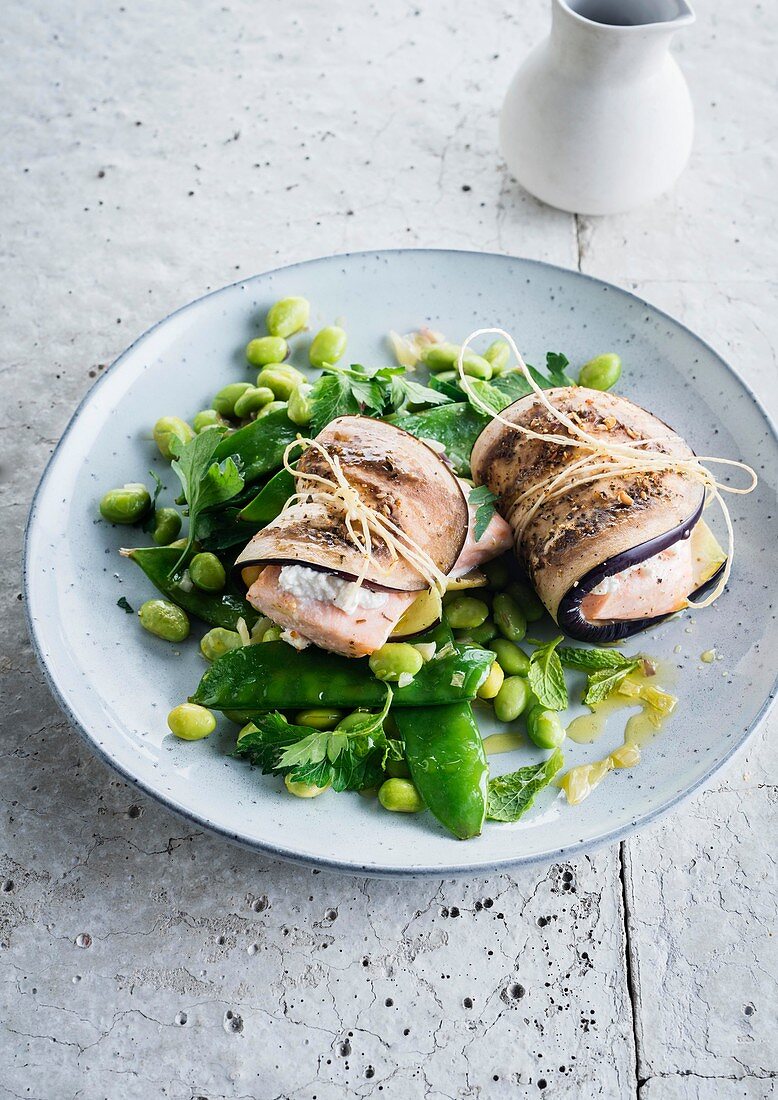 Saltimbocca of aubergine and salmon with sugar snap peas and edamames