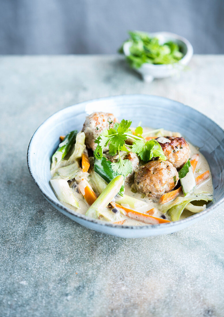 Chicken meatballs with coconut milk and vegetables