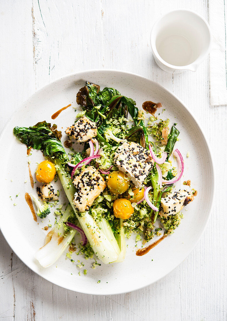 Baked pak choi with feta, broccoli and sesame seeds