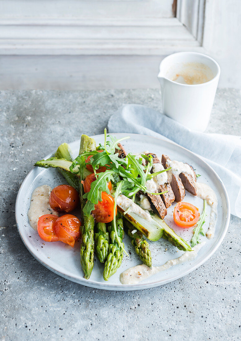 Veal with green asparagus, tomatoes and ricotta sauce