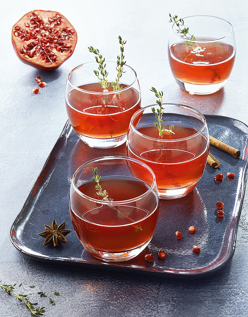 Pomegranate and Cognac cocktail with thyme
