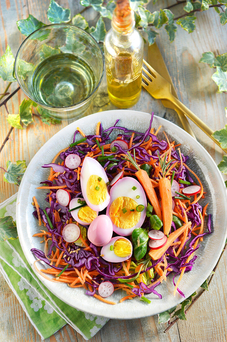 Colourful raw vegetable salad with boiled eggs for Easter