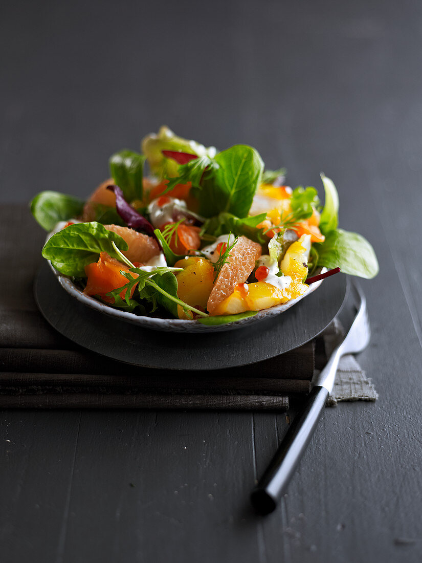 Salad with smoked fish and winter fruit