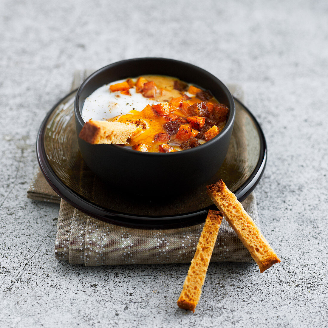 Oeuf cocotte with carrots and spiced bread