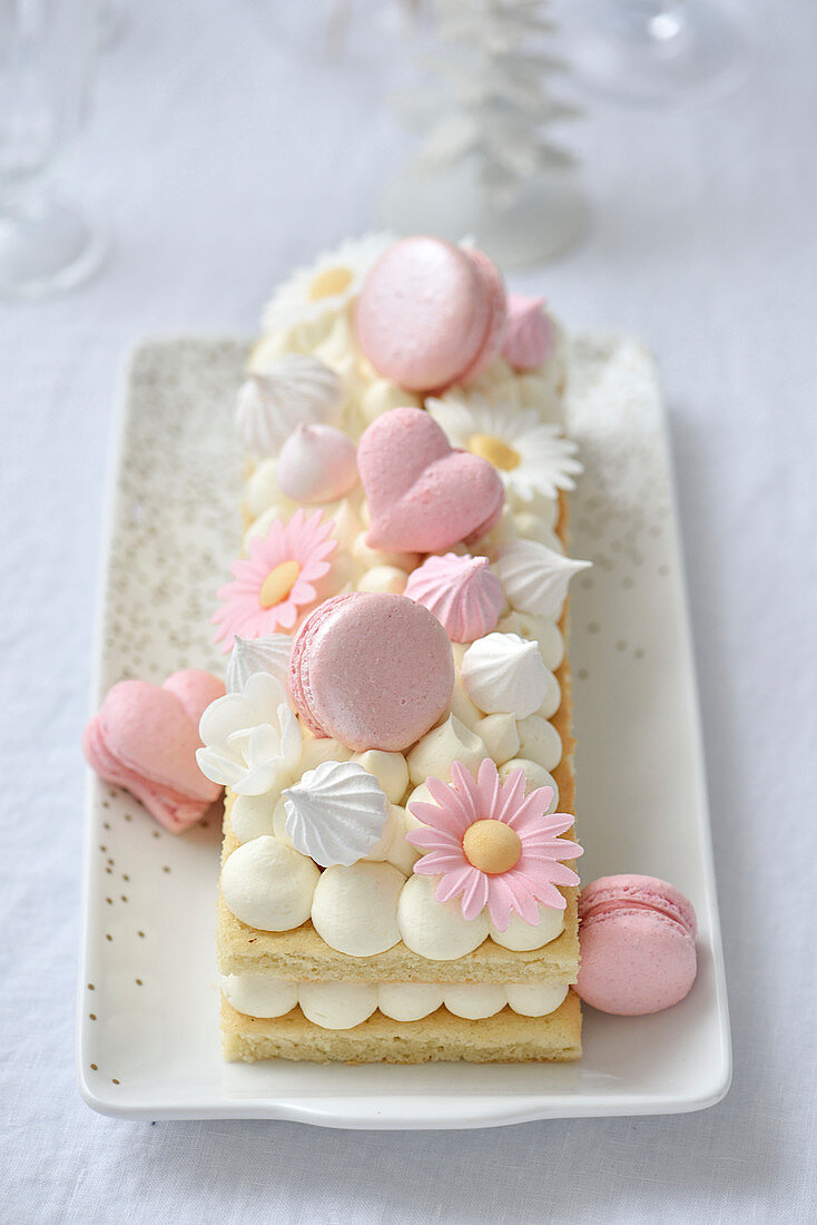 Spring cake with cream dots, macarons and flower decorations