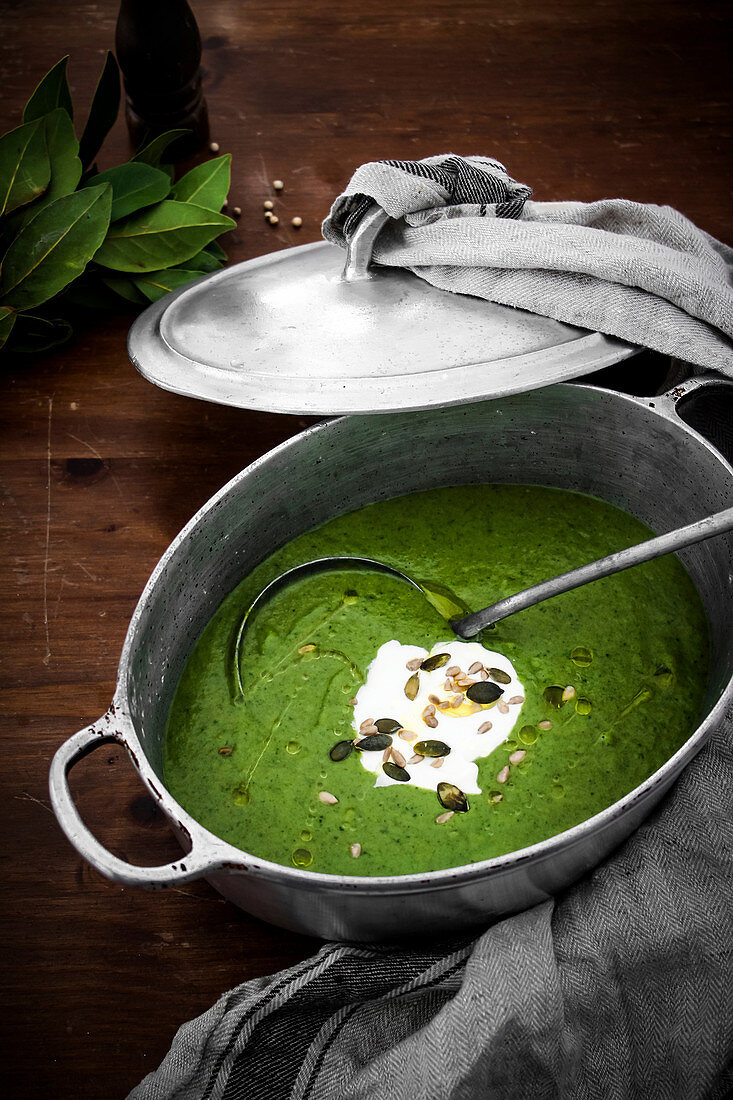 Green leek soup with pumpkin seeds in a saucepan