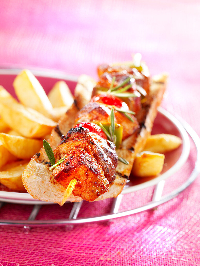 Baguette sandwich with a lamb skewer and chips