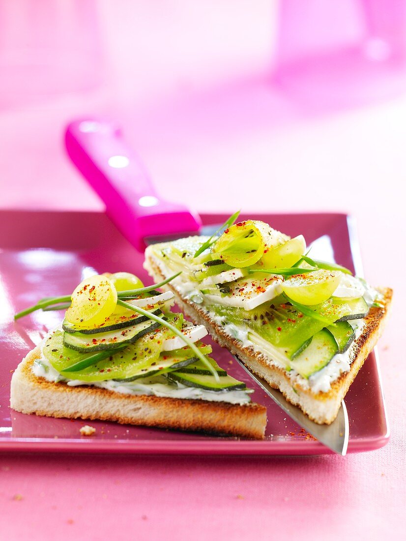Toast with cream cheese, cucumber, kiwi and grapes