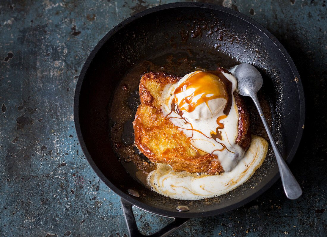 French toast with vanilla ice cream and toffee sauce in a pan