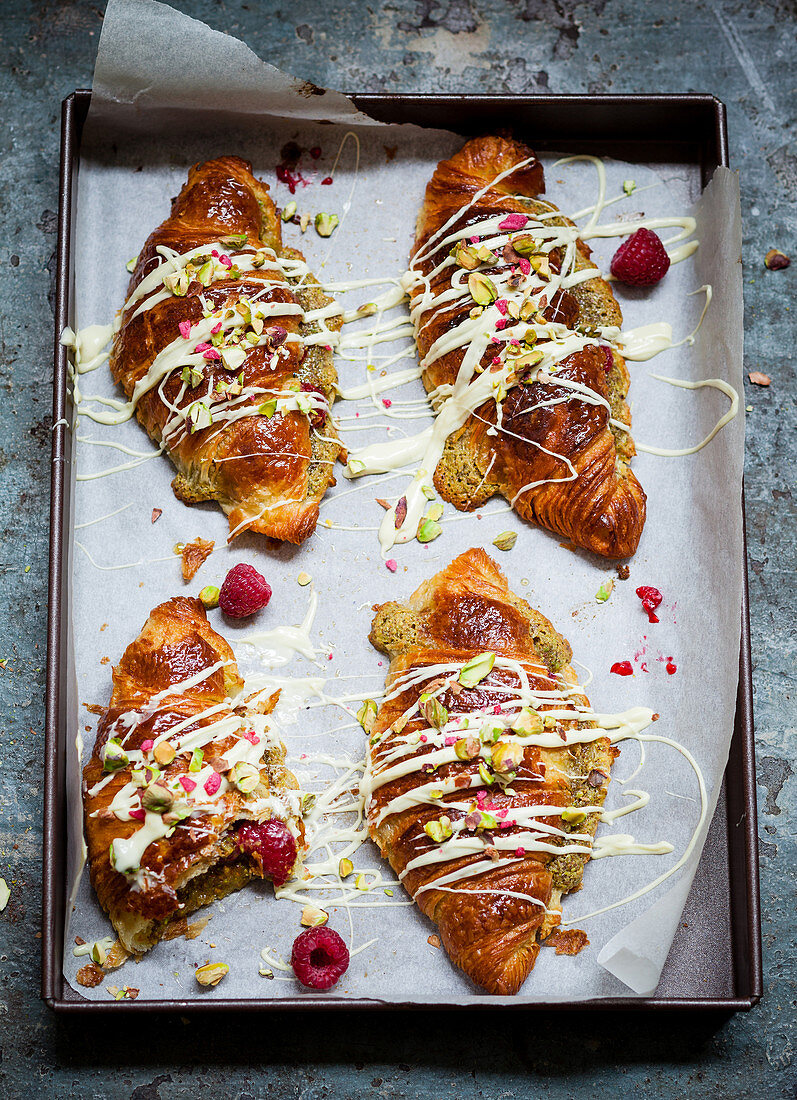 Pistachio croissants with white chocolate and raspberries
