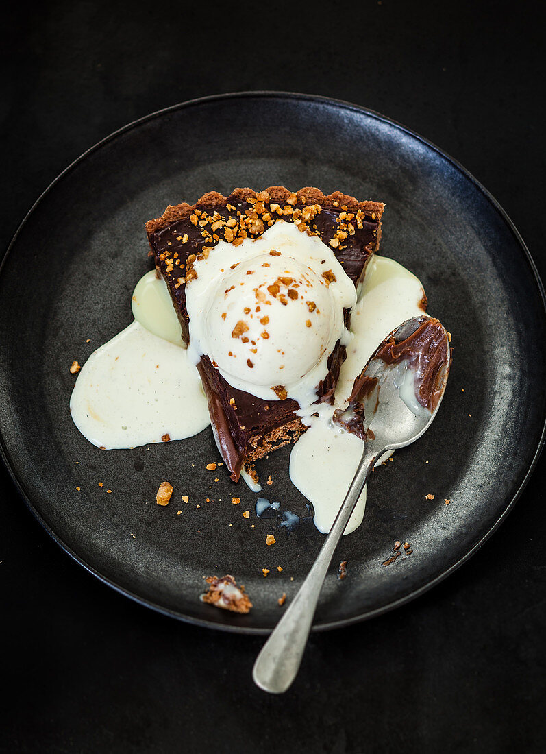 A piece of chocolate tart with vanilla ice cream