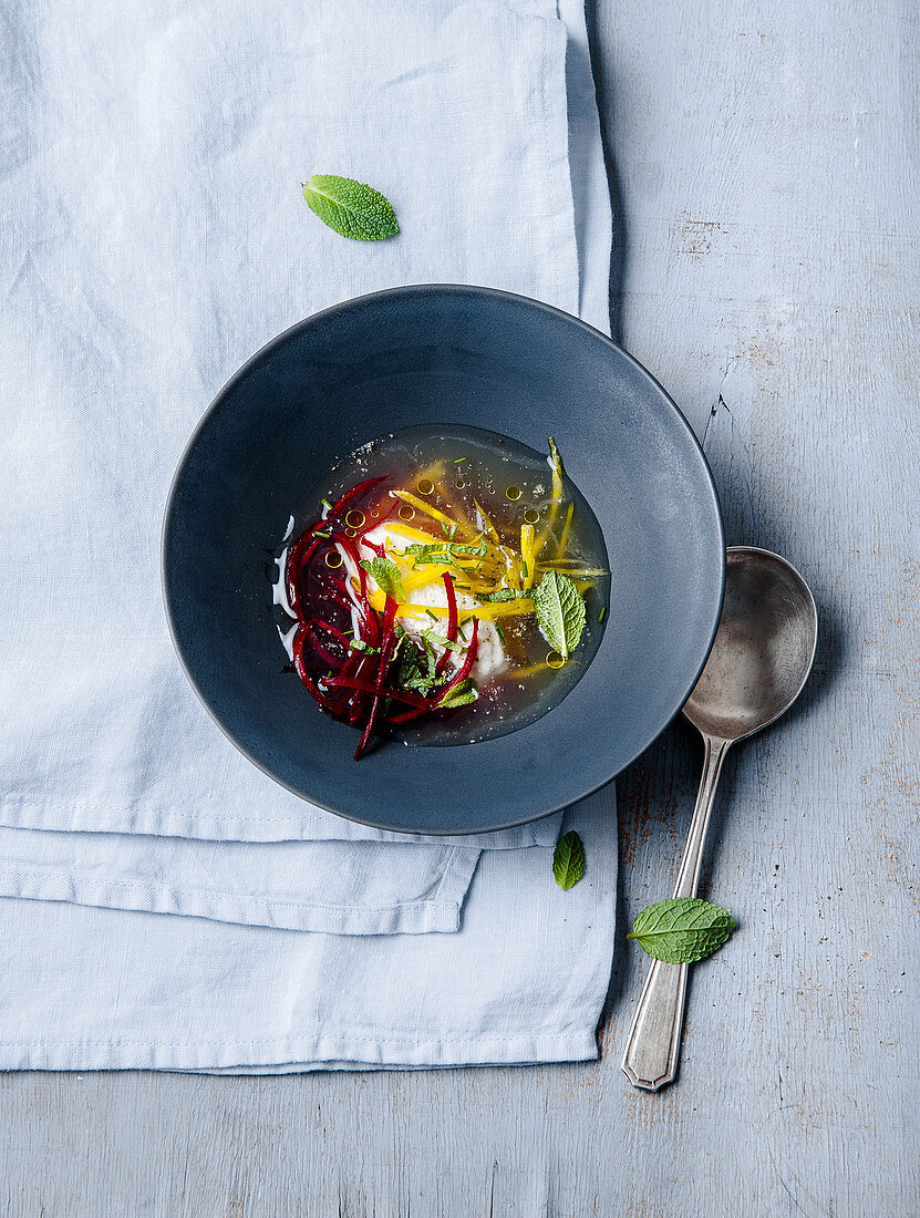 Broth with beets and goat’s cheese