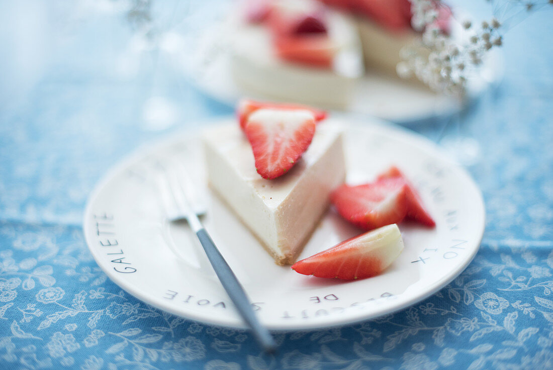 A slice of tofu cheesecake with strawberries