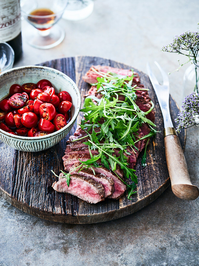 Grilled beef fillet with rocket and cherry tomato salad with balsamic vinegar