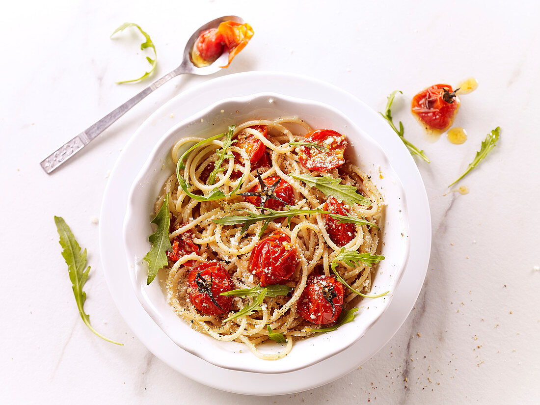 Spaghetti with confit cherry tomatoes, parmesan and rocket salad