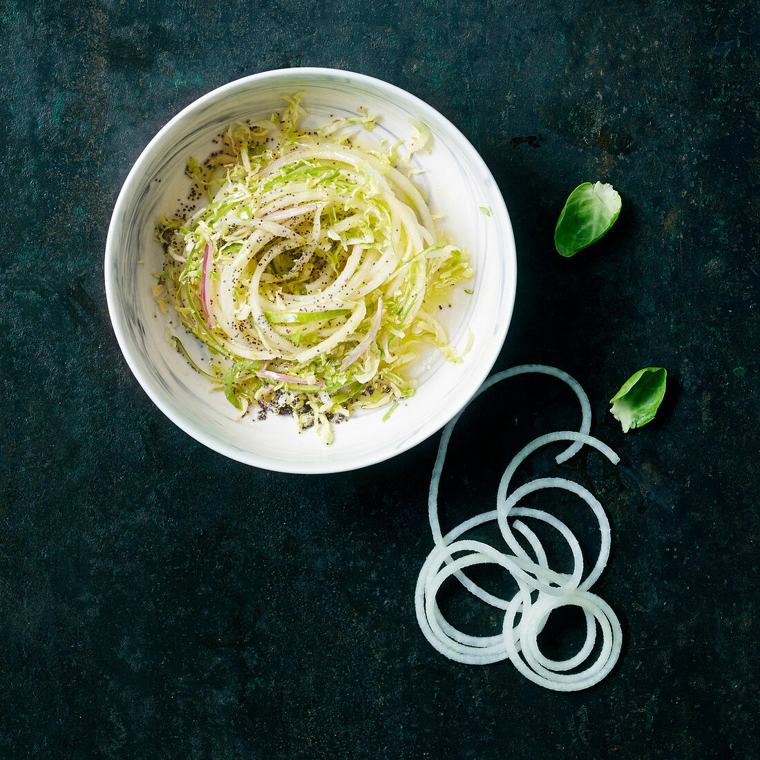 Pasta nest of white cabbage spaghetti with apple and chia seeds