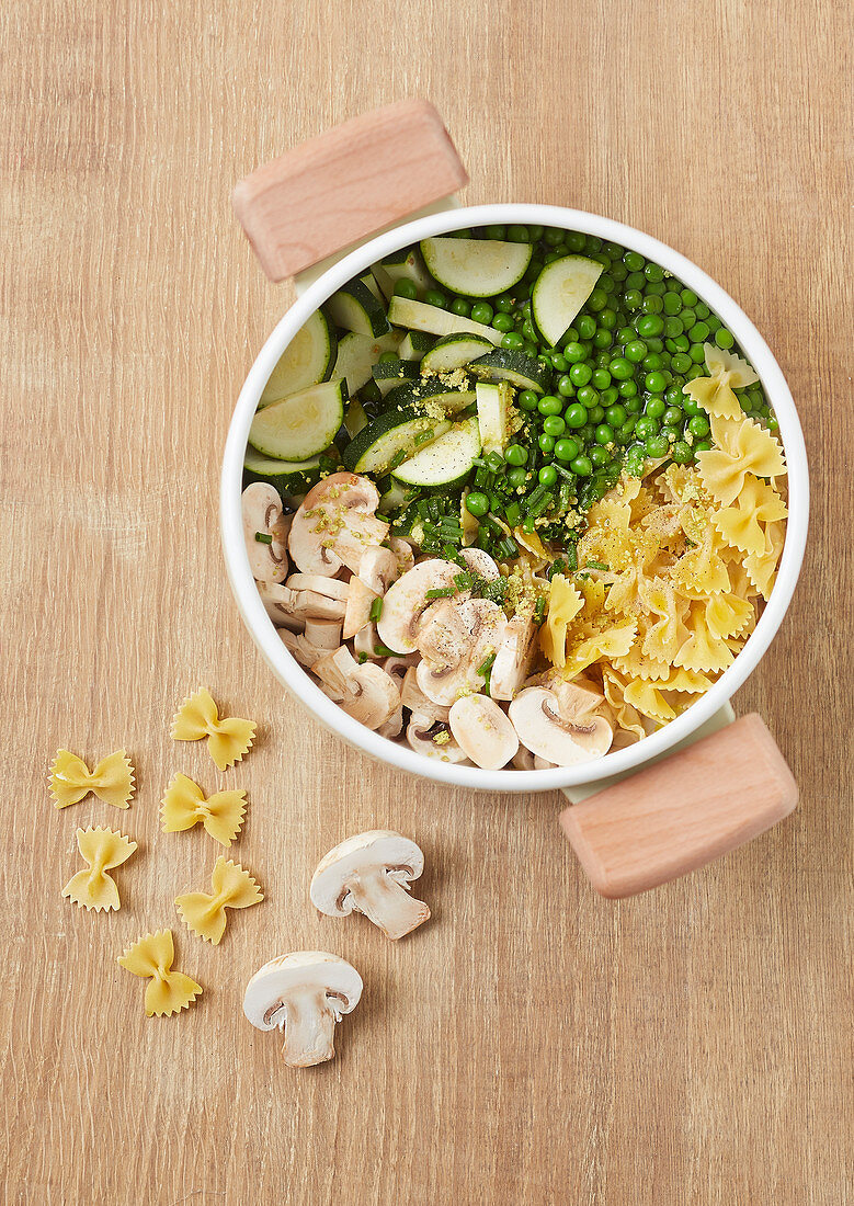 Ingredients for making farfalle with peas, courgettes and mushrooms