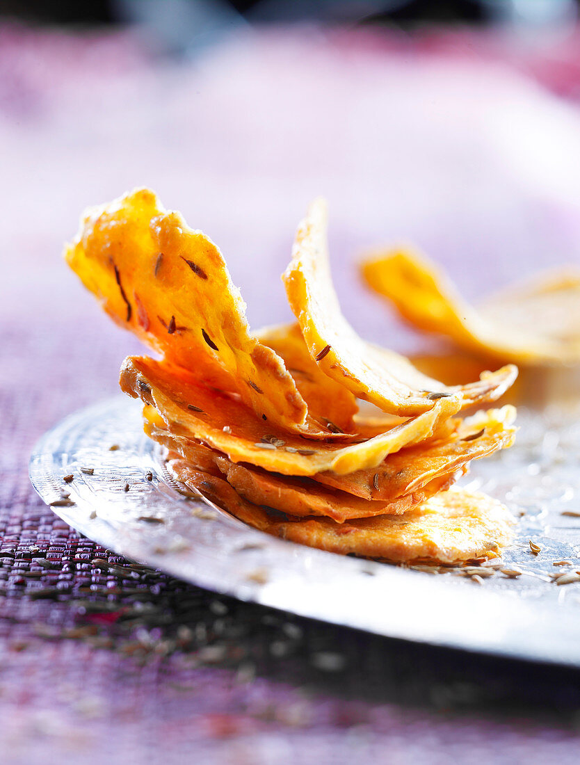 Oriental chips with spices on a silver plate