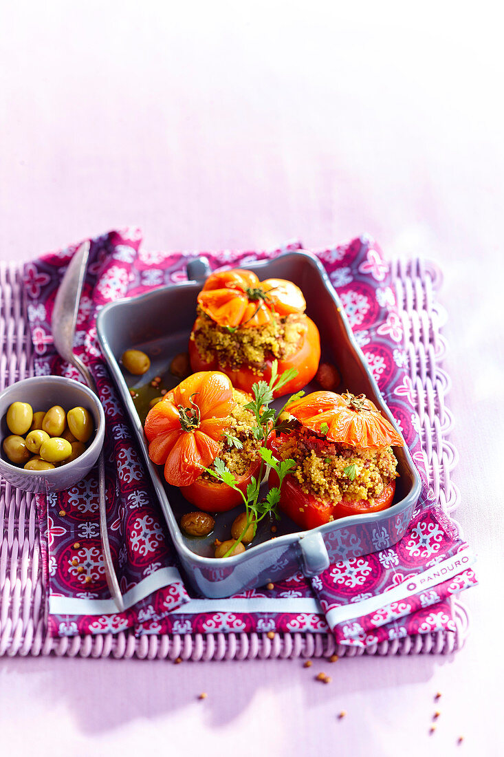 Stuffed tomatoes with couscous, lamb and olives
