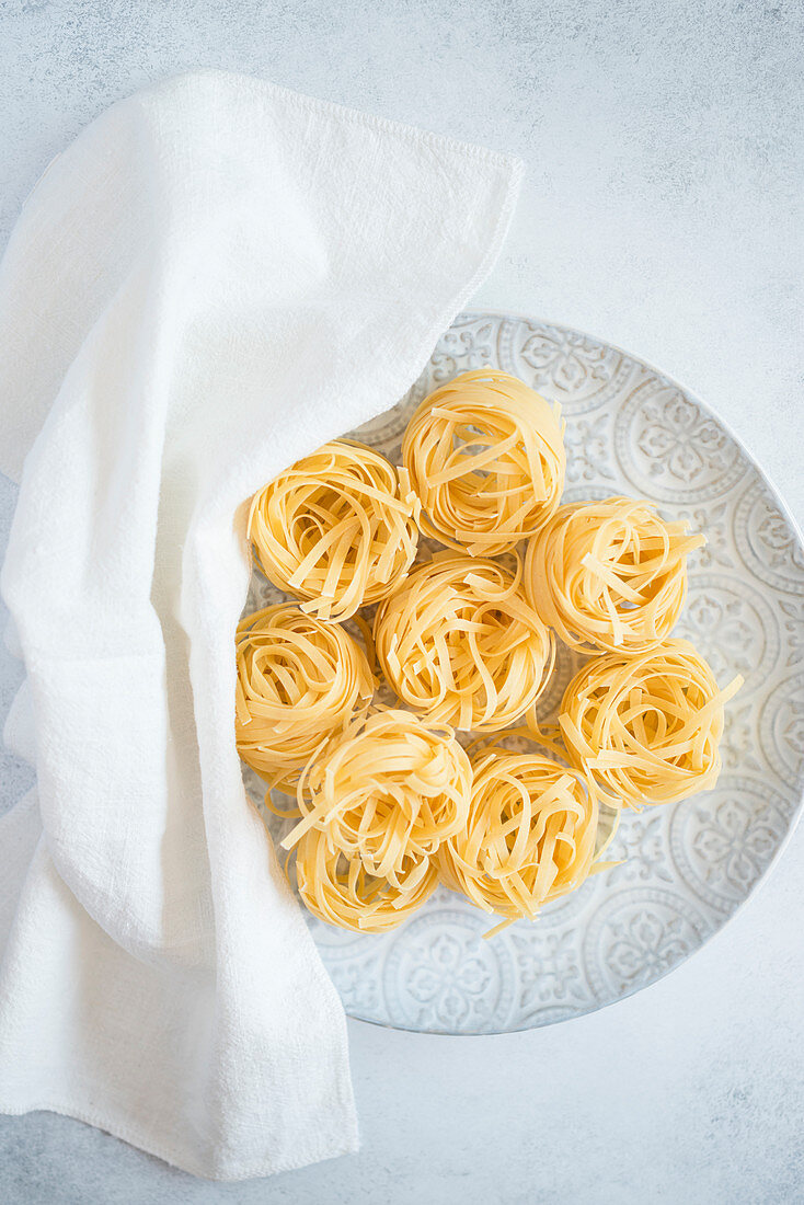 Uncooked ribbon noodle nests