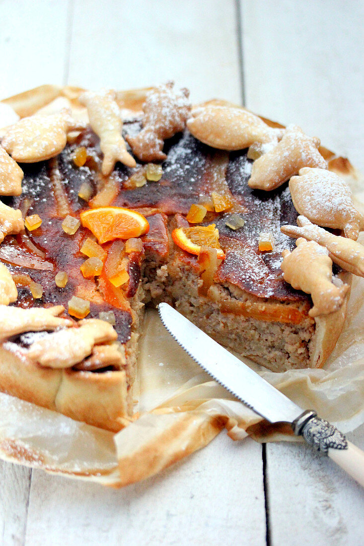 Spicy cake with seafood and candied oranges