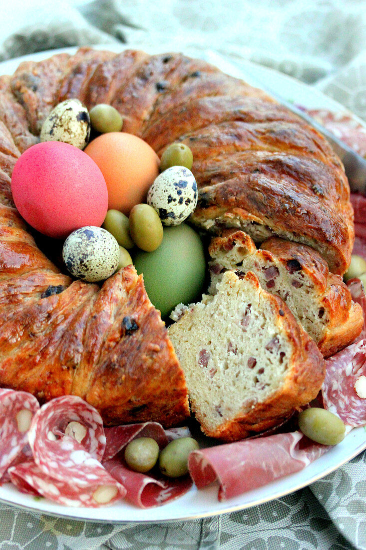 Savoury Easter wreath with bacon decorated with eggs and olives