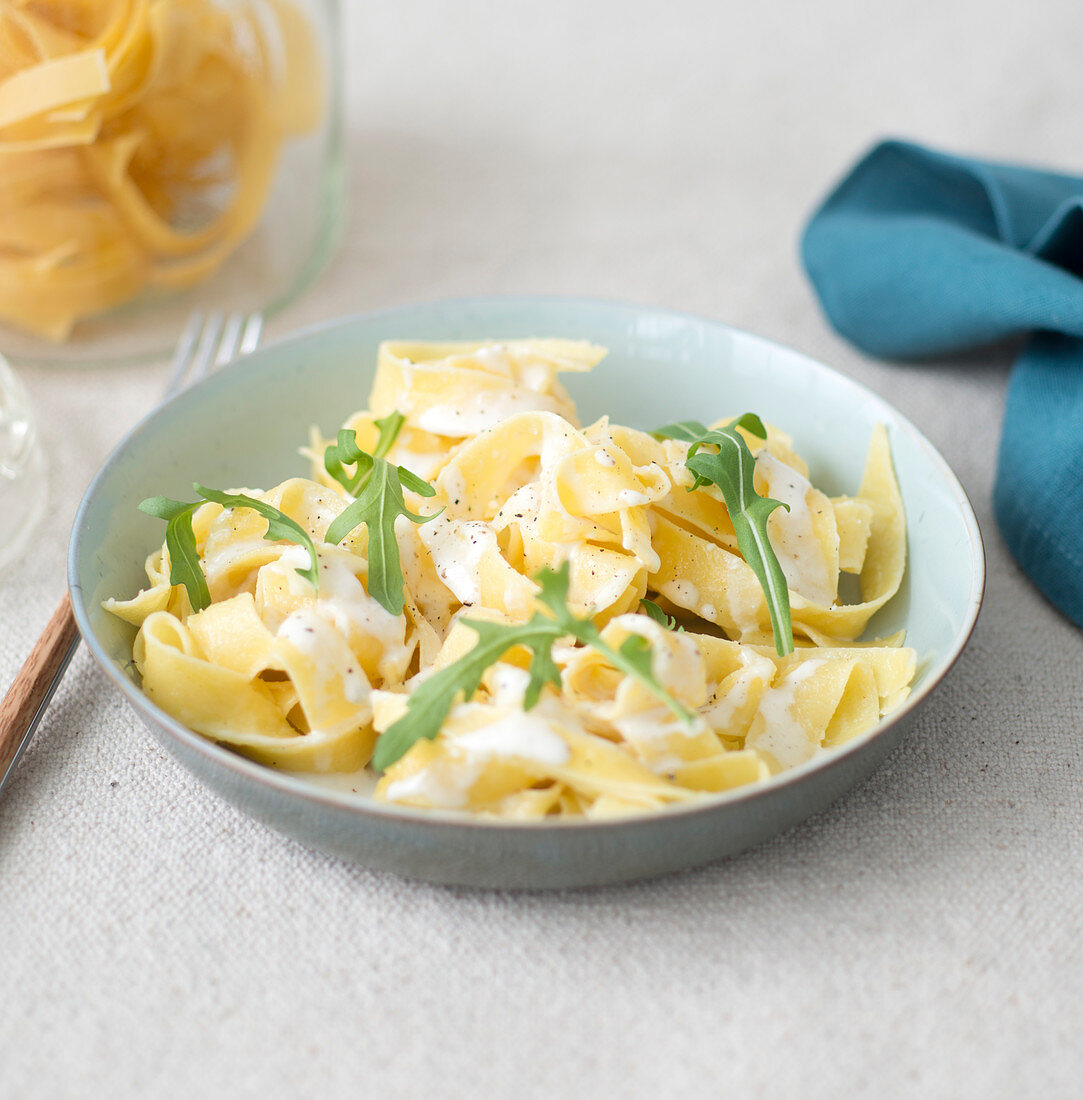 Pasta with cheese and rocket lettuce