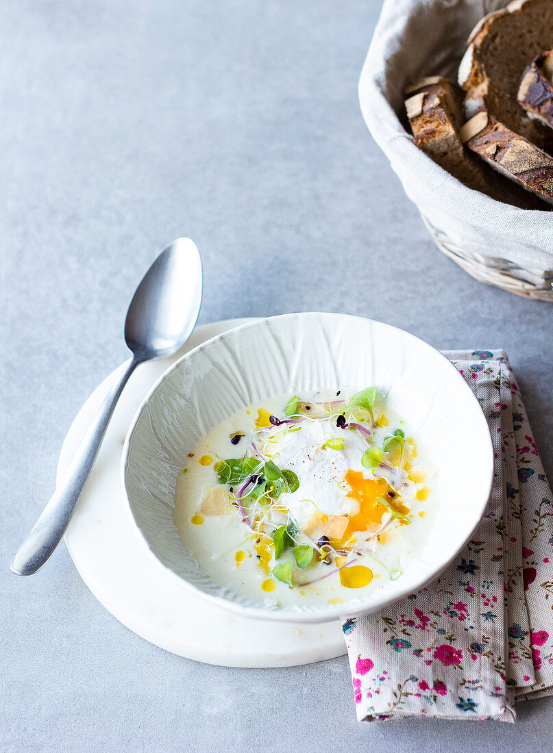 Cream of asparagus soup with poached egg and sprouts