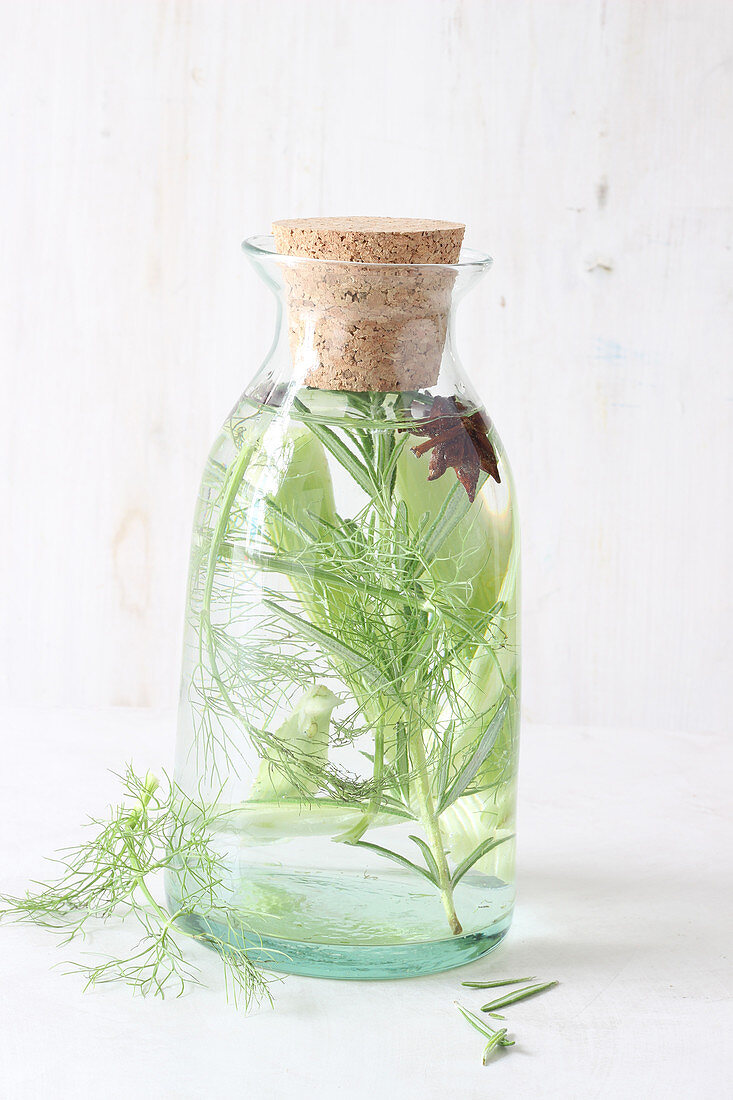 Detox water with herbs in a glass bottle