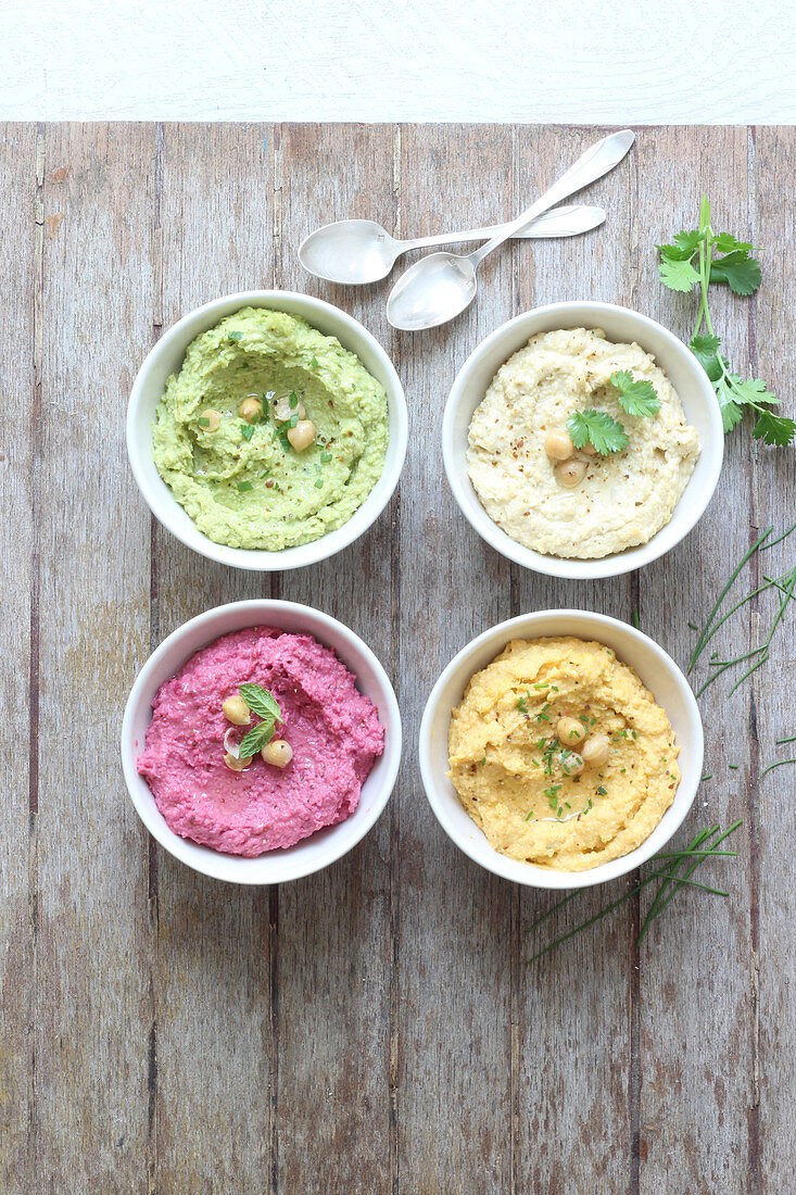 Four different hummus in bowls
