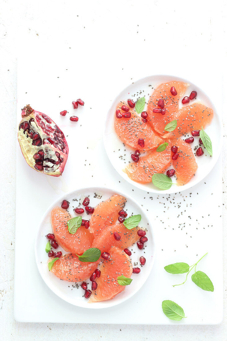 Pink grapefruit in wedges with pomegranate seeds